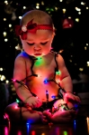 Baby wrapped in lights